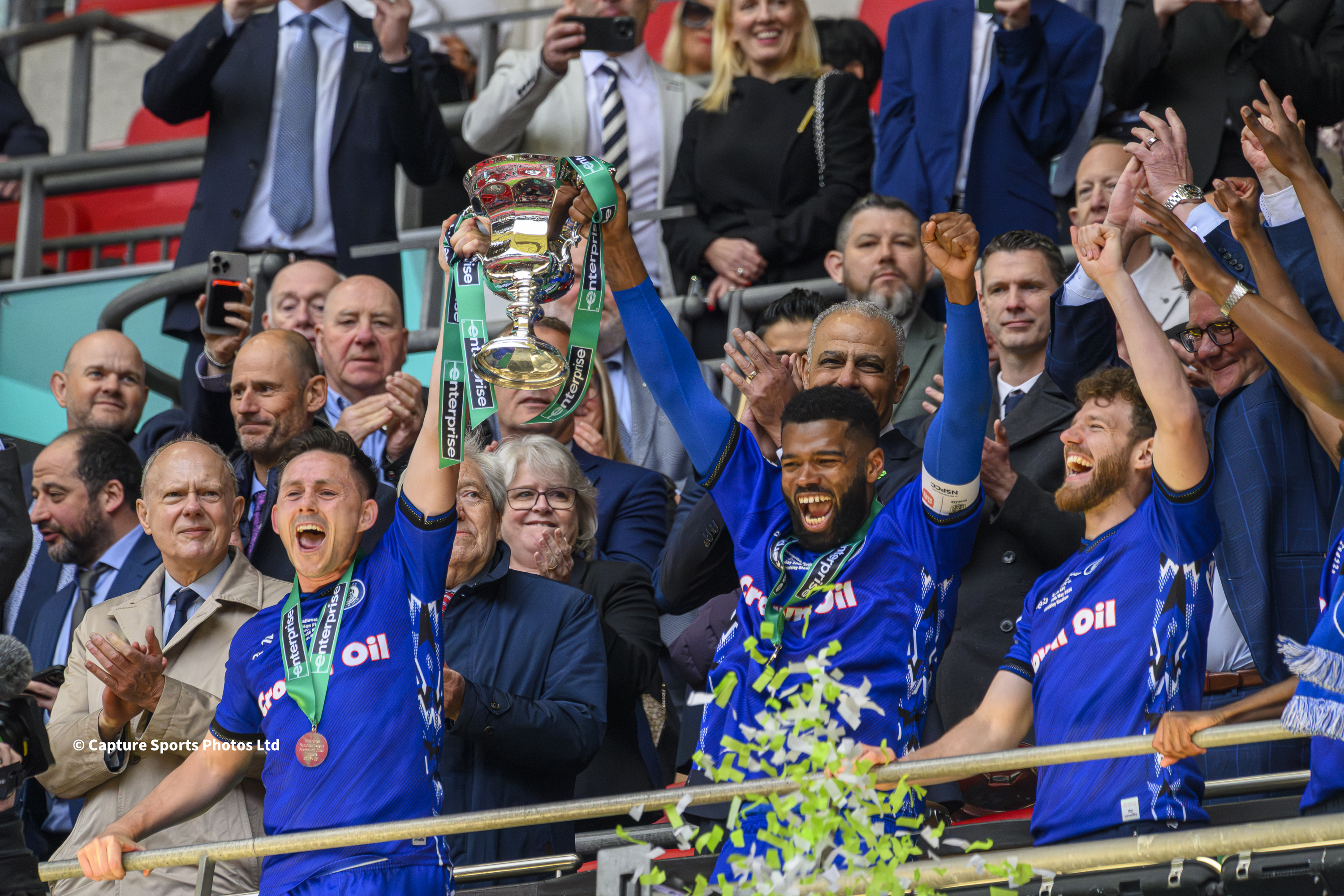 Wembley Stadium, London: 2026 July 10: Ian Henderson and Ethan Ebanks-Landell of Rochdale celebrates with the play off trophy following the Enterprise National League Promotion Play-off Final match between Rochdale and Boreham Wood
